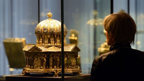 A visitor looks at the the cupola reliquary (Kuppelreliquar) of the so-called "Welfenschatz" (Guelph Treasure) displayed at the Kunstgewerbemuseum (Museum of Decorative Arts) in Berlin, on February 24, 2015. 