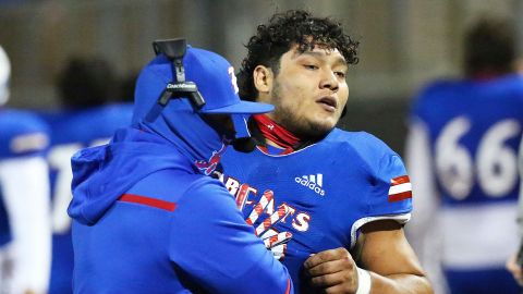 Edinburg High's Emmanuel Duron is pulled from the field by coaching staff during a football game on December 3, 2020, in Edinburg, Texas.