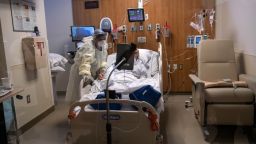  A nurse stands with a COVID-19 patient during a Zoom video call in a Stamford Hospital intensive care unit (ICU), on April 24, 2020 in Stamford, Connecticut. 