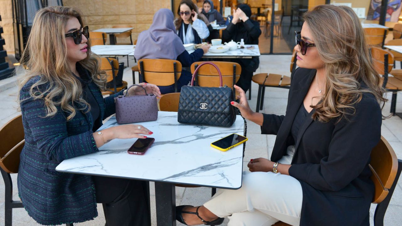 Saudi women chat in a coffee shop -- until recently they would've needed to cover their heads and be accompanied by a man.