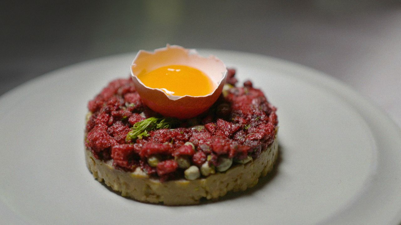Design student Sorawut Kittibanthorn has created an alternative protein using chicken feathers. He showcases them in high-end gourmet dishes, like this "beef" tartare with smashed avocado, raw egg yolk, red onion, parsley, dill, chili flakes and capers. 