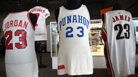Michael Jordan's 1984 signing day Chicago Bulls jersey is displayed beside President Barack Obama's high school basketball jersey and a Cleveland Cavaliers jersey worn by LeBron James.