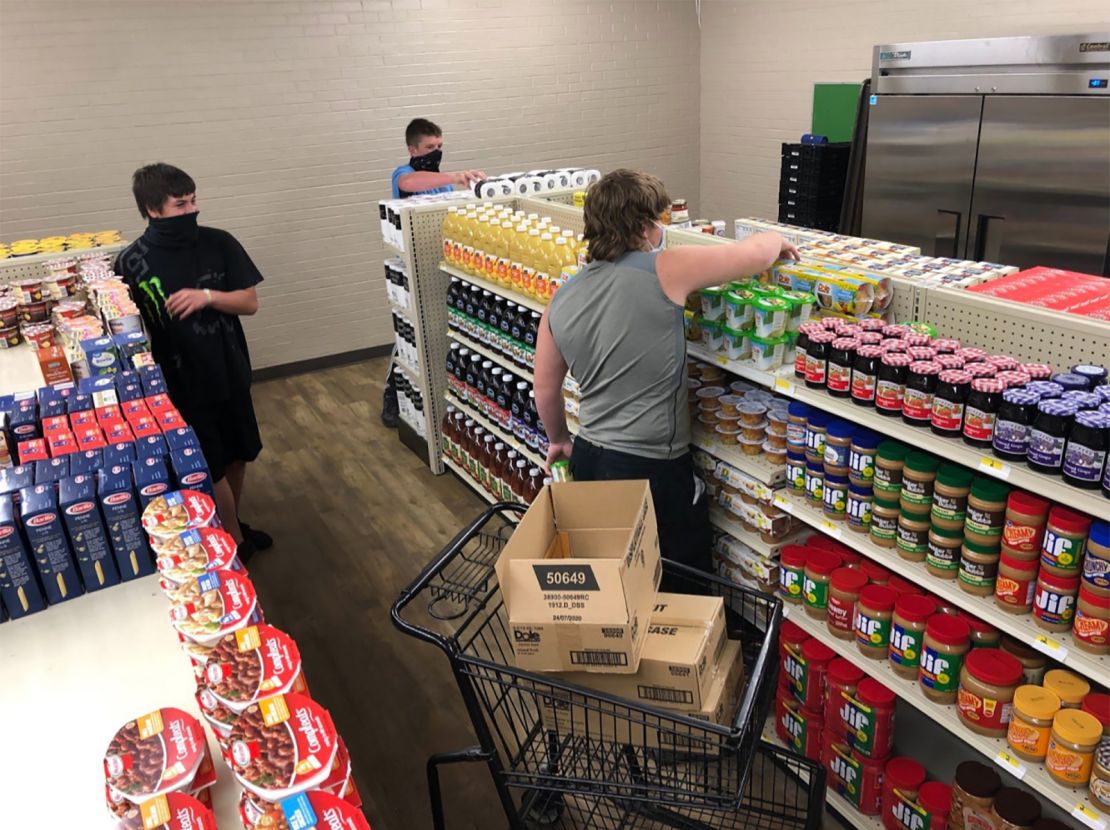 Westbrook, pictured in the grey shirt, and two of his classmates stocking the shelves at the grocery store.