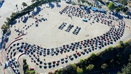 LOS ANGELES, CALIFORNIA - NOVEMBER 30: In an aerial view from a drone, cars are lined up at Dodger Stadium for COVID-19 testing on the Monday after Thanksgiving weekend on November 30, 2020 in Los Angeles, California. Health officials in Los Angeles County have issued a new limited stay-at-home order in effect for the next three weeks amid a surge in coronavirus cases. (Photo by Mario Tama/Getty Images)