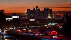 The evening rush hour commute flows past downtown Los Angeles, California on December 3, 2020. - California Governor Gavin Newsom on December 3 announced new statewide bans on gatherings and "non-essential" activities, as hospitals in the nation's most populous state face being overwhelmed by record Covid-19 cases. The limits will come into effect once 85 percent of intensive care unit beds have been filled -- a development expected in four of California's five regions "as early as the next day or two." (Photo by Frederic J. BROWN / AFP) (Photo by FREDERIC J. BROWN/AFP via Getty Images)