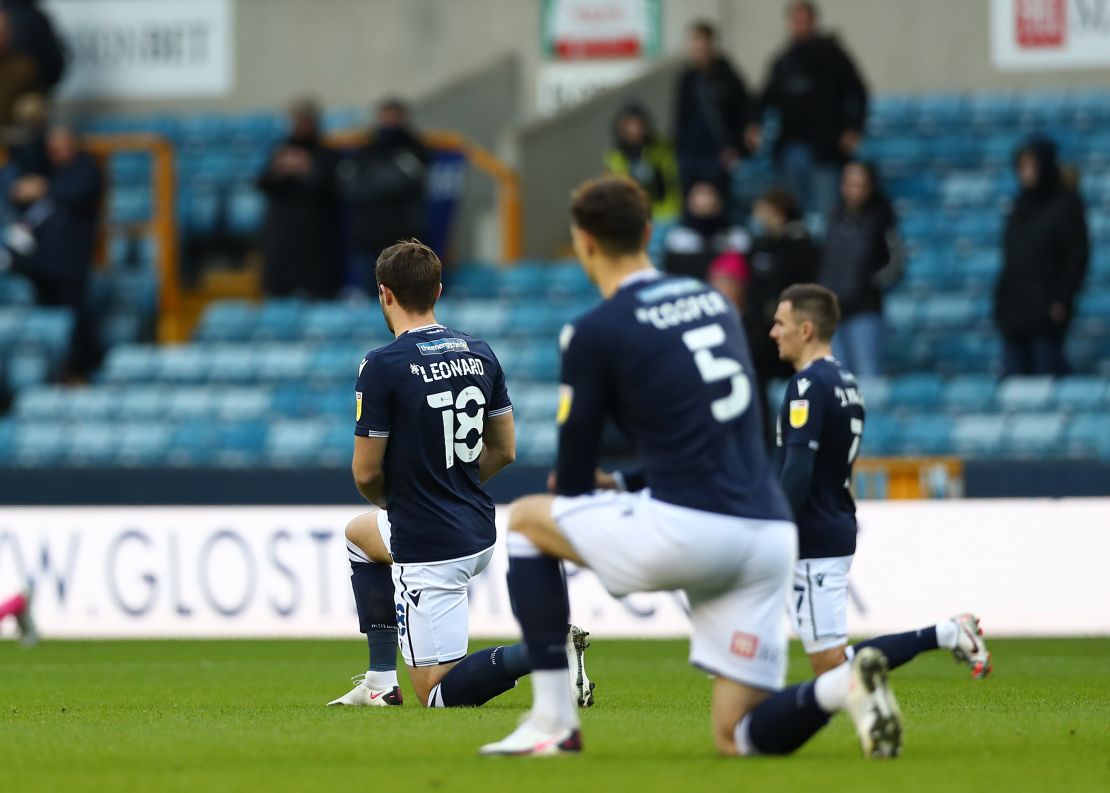 Millwall players kneel before their side's game against Derby County.