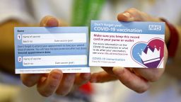 A card that will be given to patients following their Covid-19 vaccination is displayed at Croydon University Hospital in south London on Saturday after the first batch of doses were delivered.