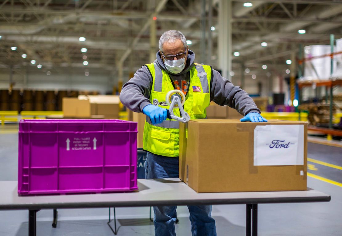 A Ford Motor Company employee packaging face masks.