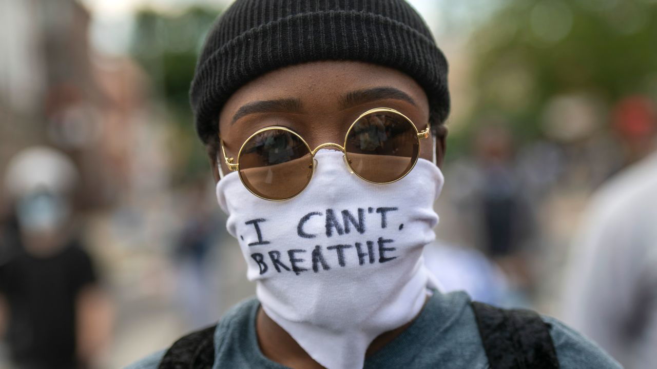A protester wears a cloth mask stating "I CAN'T BREATHE" amid widespread unrest after the death of George Floyd in Philadelphia.