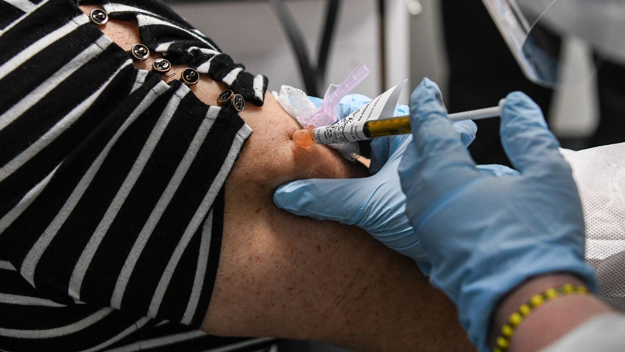 Sandra Rodriguez, 63, receives a Covid-19 vaccination on August 13 at the Research Centers of America in Hollywood, Florida, as part of Phase 3 clinical trials.