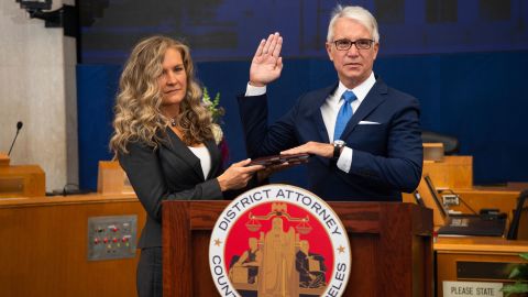 Incoming Los Angeles County District Attorney George Gascón is sworn in as his wife, Fabiola Kramsky, holds a copy of the Constitution.