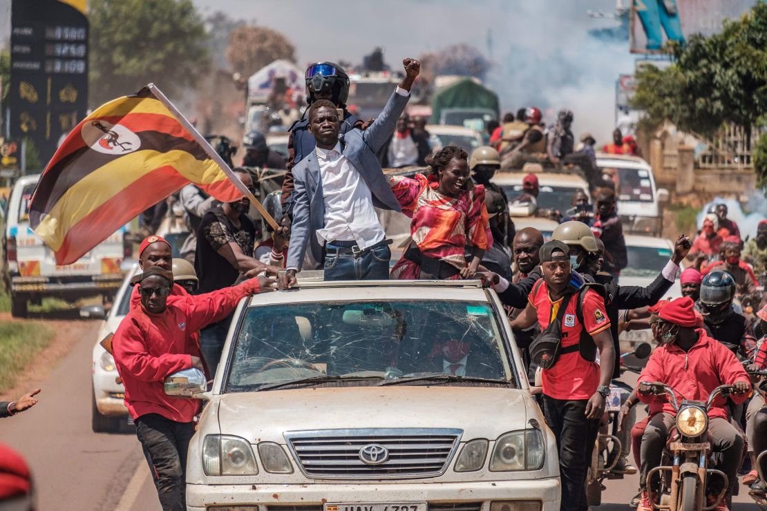 Bobi Wine greets supporters as he sets off on the campaign trail towards eastern Uganda, near Kayunga, on December 1.