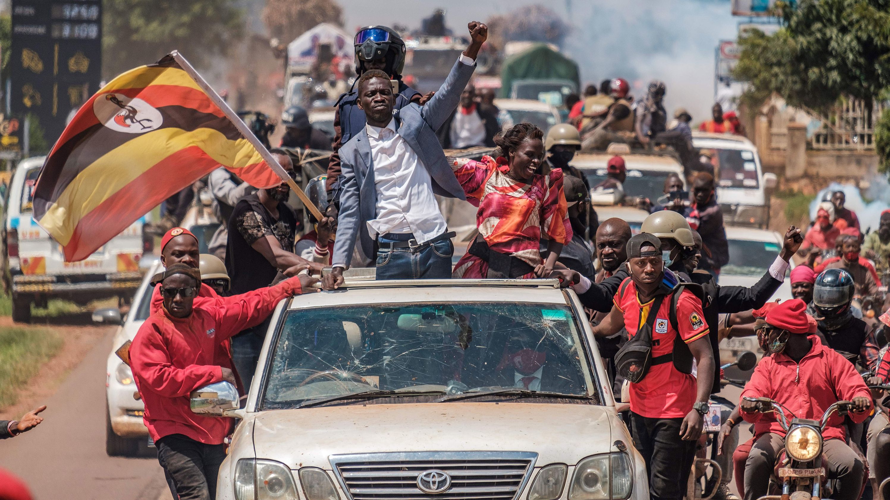 Bobi Wine greets supporters as he sets off on the campaign trail towards eastern Uganda, near Kayunga, on December 1.