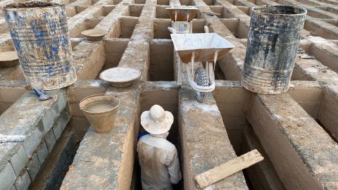 The uniform, tidy graves of the Behest-e-Zahra cemetery are swallowed in the reverberating and haunting chants of imams working overtime to pray for the endless stream of shrouded corpses.