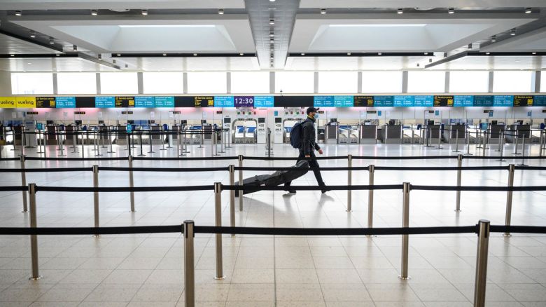 LONDON, ENGLAND - NOVEMBER 27: A passenger walks past the deserted check-in desks and passenger facilities in the North Terminal at Gatwick Airport on November 27, 2020 in London, England. Gatwick airport is launching a facility to purchase PCR swab tests, allowing passengers to travel to destinations which require them to prove they are Covid-free. Due to the COVID-19 pandemic, the number of travellers has fallen dramatically. During the period between July and September, the airport registered an 86% drop in passengers compared to the same period in 2019. The service, provided by ExpressTest, charges £60 per passenger flying from Gatwick, or £99 for general members of the public. (Photo by Leon Neal/Getty Images)