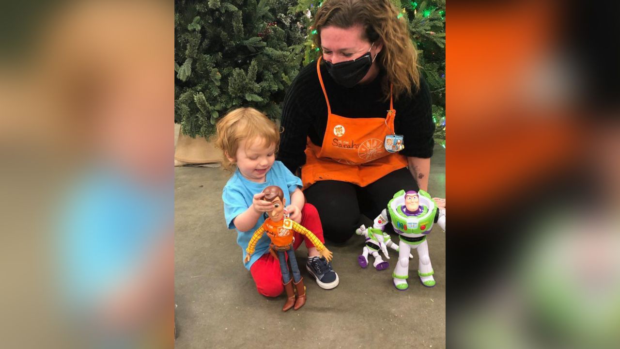 Sarah Hurberdeau, an associate at The Home Depot,  helps reunite 2-year-old Desmond with his lost Woody doll. 