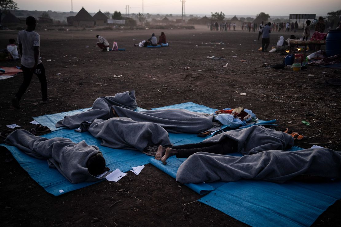 People sleep outside at the camp.