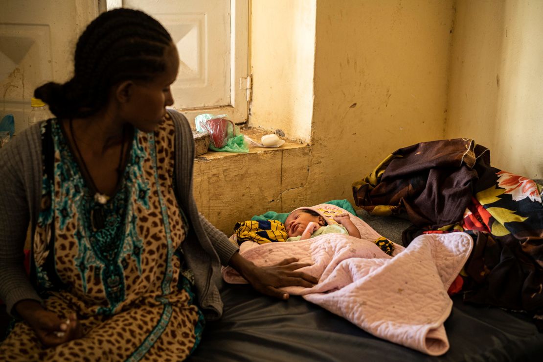 A young mother and her newborn baby rest at the Hamdayat camp. She fled violence in Humera, an Ethiopian town near the border.