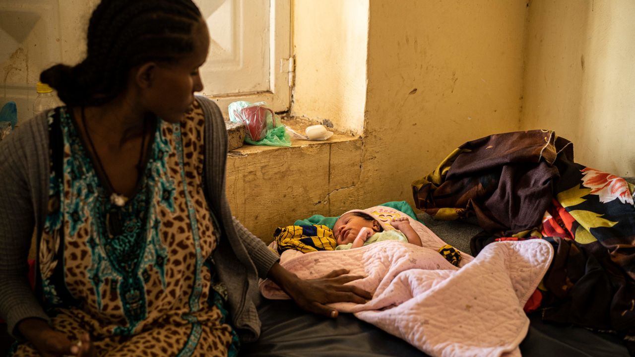 A young mother and her newborn baby rest at the Hamdayat camp. She fled violence in Humera, an Ethiopian town near the border.