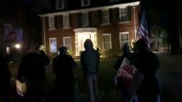 Protesters gather outside the home of Michigan's Secretary of State Jocelyn Benson.