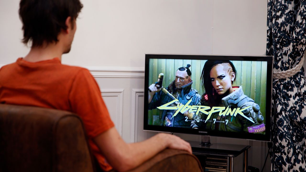 A player looks at tthe teaser for the video game Cyberpunk 2077.