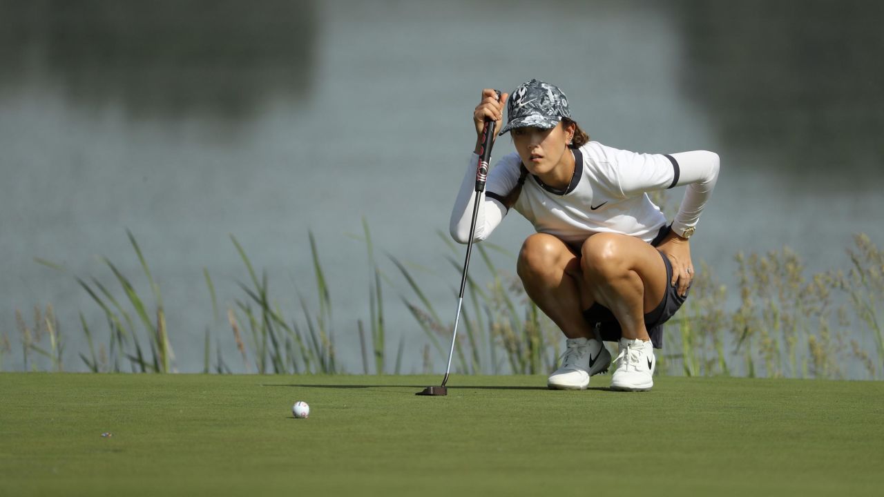 Wie lines up a putt on the 10th green during the first round of the PGA Championship.