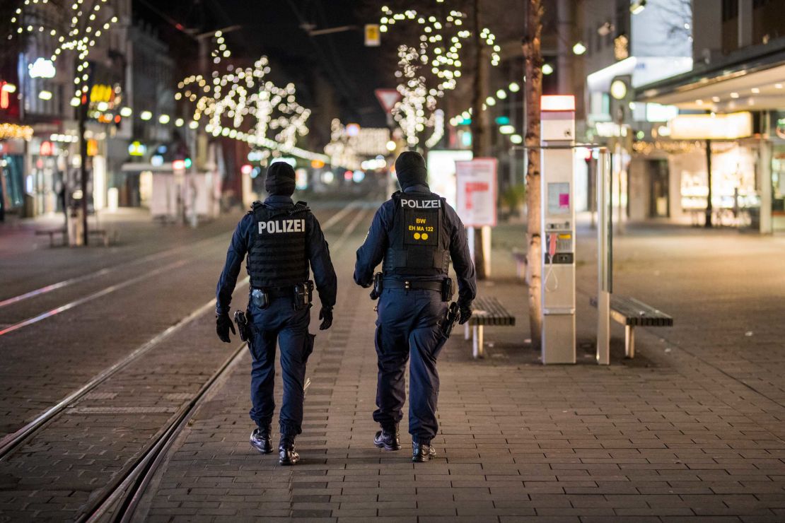 Police officers walk in an empty pedestrian shopping street on December 8 in Mannheim, one of  several German cities to have imposed a post-9 p.m. curfew.