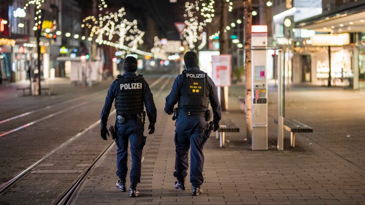 Police officers walk in an empty pedestrian shopping street on December 8 in Mannheim, one of  several German cities to have imposed a post-9 p.m. curfew.