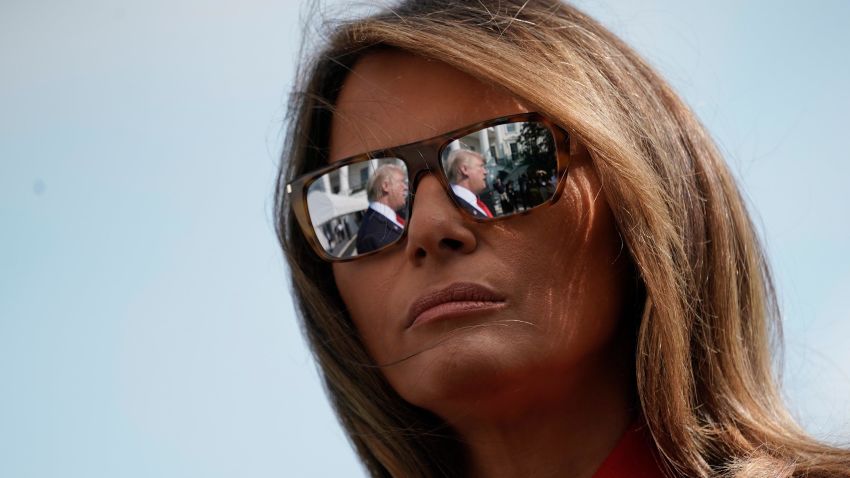 President Donald Trump's reflections are seen in the first lady Melania Trump's sunglasses as the president stops to answers questions on at South Lawn of the White House in Washington, Sunday, Sept. 10, 2017.