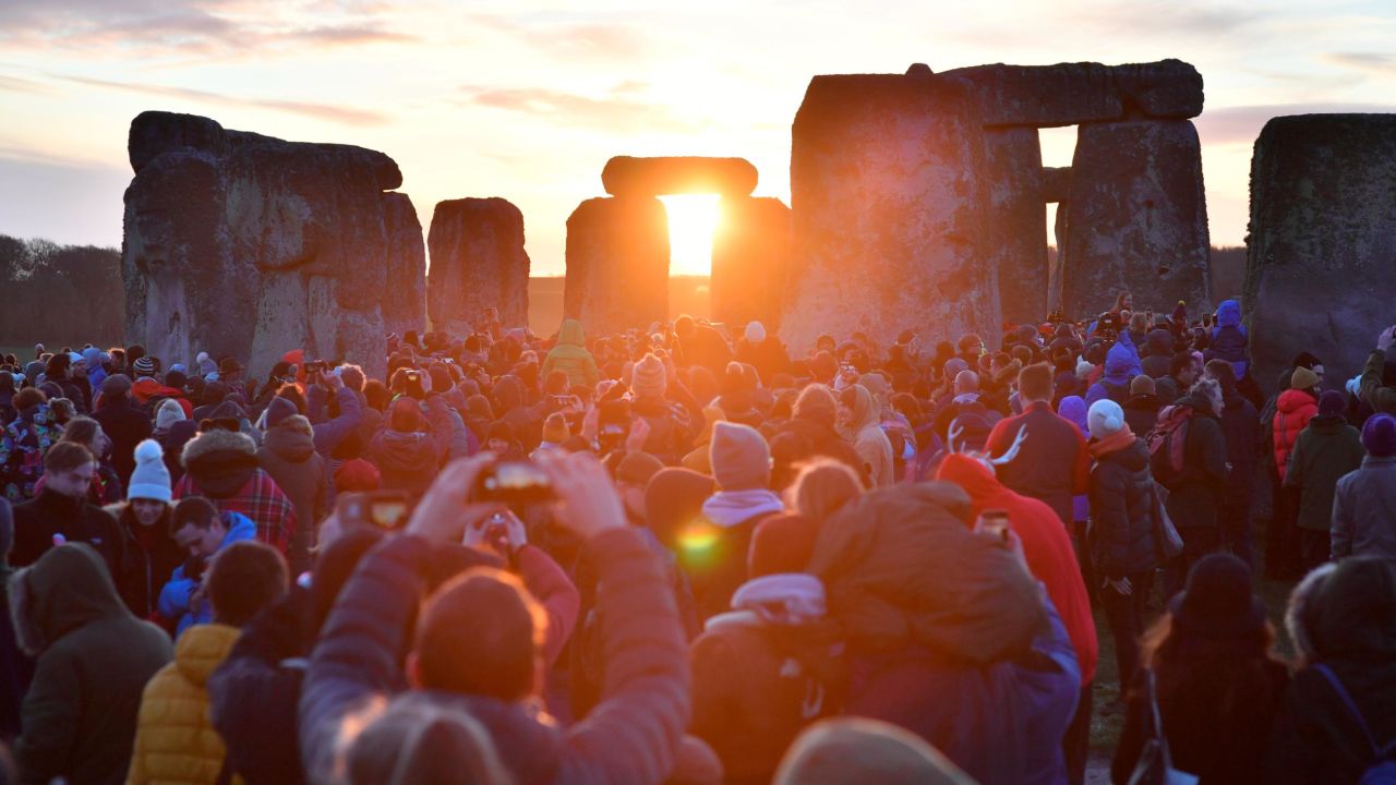 People watch the sunrise at Stonehenge in Wiltshire, England, to mark the winter solstice and witness the sunrise after the longest night of the year.