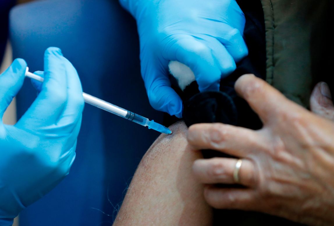 A nurse administers a Covid-19 vaccine in London on Tuesday, December 8.