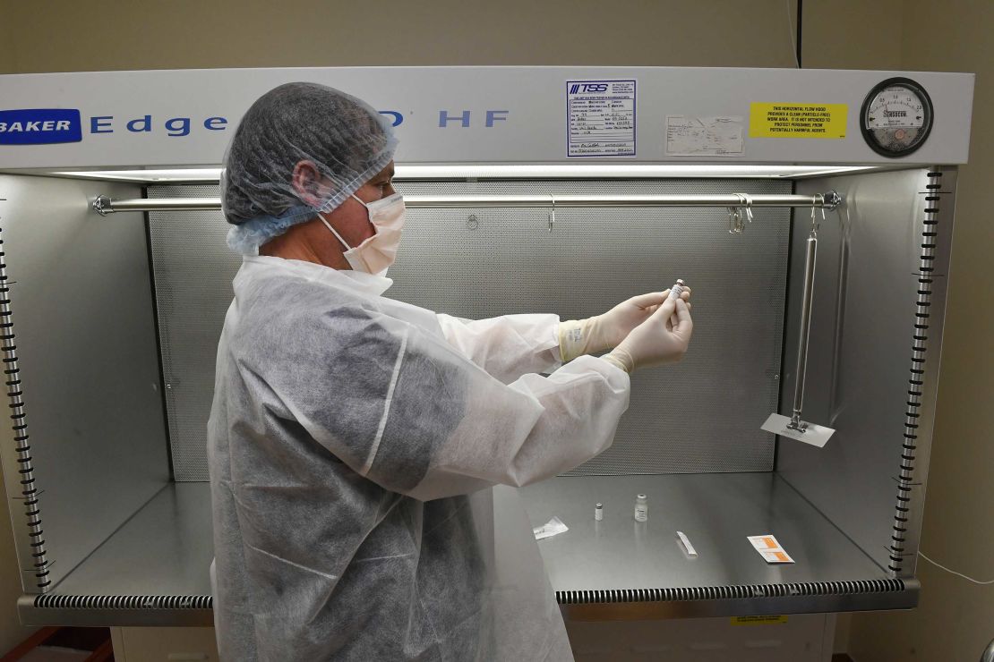 Vail Health Hospital pharmacy technician Rob Brown works on practicing the procedure of reconstituting mock Covid-19 vaccines in the sterile compounding room in the pharmacy on December 8, 2020, in Vail, Colorado.  
