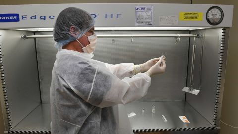 Vail Health Hospital pharmacy technician Rob Brown works on practicing the procedure of reconstituting mock Covid-19 vaccines in the sterile compounding room in the pharmacy on December 8, 2020, in Vail, Colorado.  
