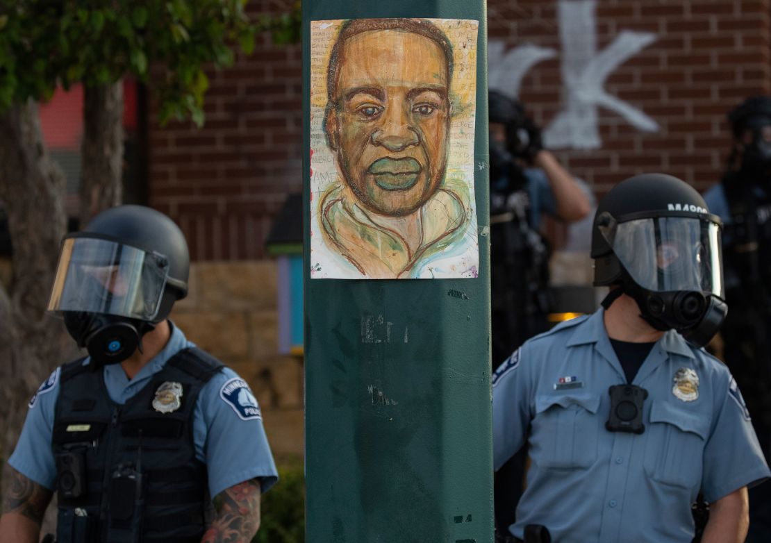 Minneapolis police watched the demonstrators protested the killing of George Floyd outside the Minneapolis Police Department's Third Precinct office in south Minneapolis.