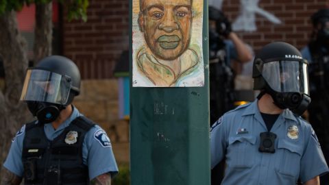 Minneapolis police watched the demonstrators protested the killing of George Floyd outside the Minneapolis Police Department's Third Precinct office in south Minneapolis.
