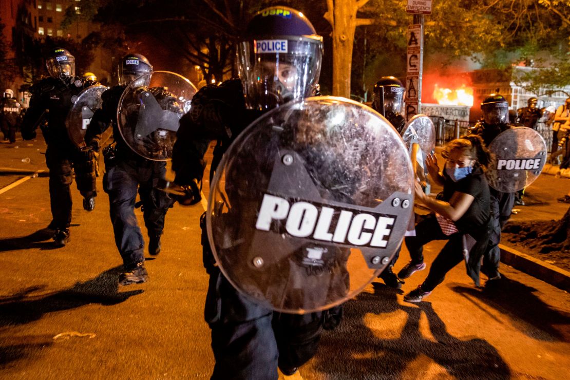 A police officer charges forward as people protest the death of George Floyd in front of the White House in Washington, D.C. on May 31.