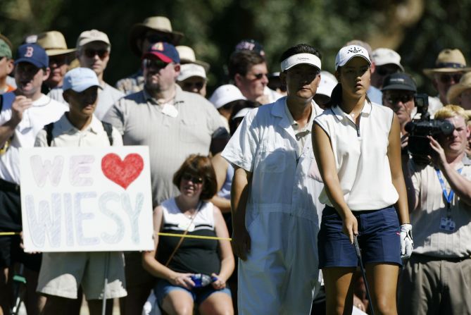 <strong>Golf prodigy:</strong> Michelle Wie aims for a tee shot as her father B.J. looks on during the final round of the Kraft Nabisco Championship at Mission Hills Country Club in 2003.