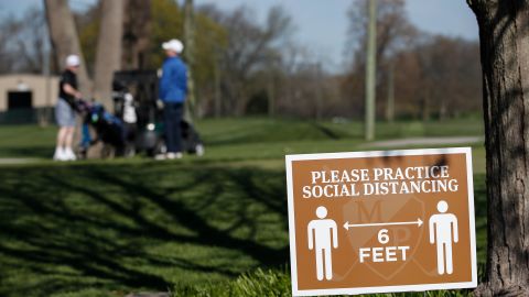 A sign informs golfers to practice social distancing at the Mt. Prospect Golf Club in Mt. Prospect, Illinois.