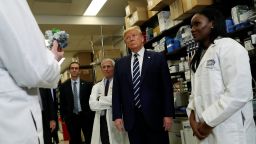 U.S. President Donald Trump is flanked by Director of National Institute of Allergy and Infectious Diseases Anthony Fauci and National Institutes of Health Doctor Kizzmekia Corbett, research fellow at the NIH Vaccine Research Center, as he listens to Doctor Barney Graham, deputy director of the National Institute of Allergy and Infectious Diseases, following a briefing at the Vaccine Research Center in Bethesda, Maryland, U.S., March 3, 2020. REUTERS/Leah Millis