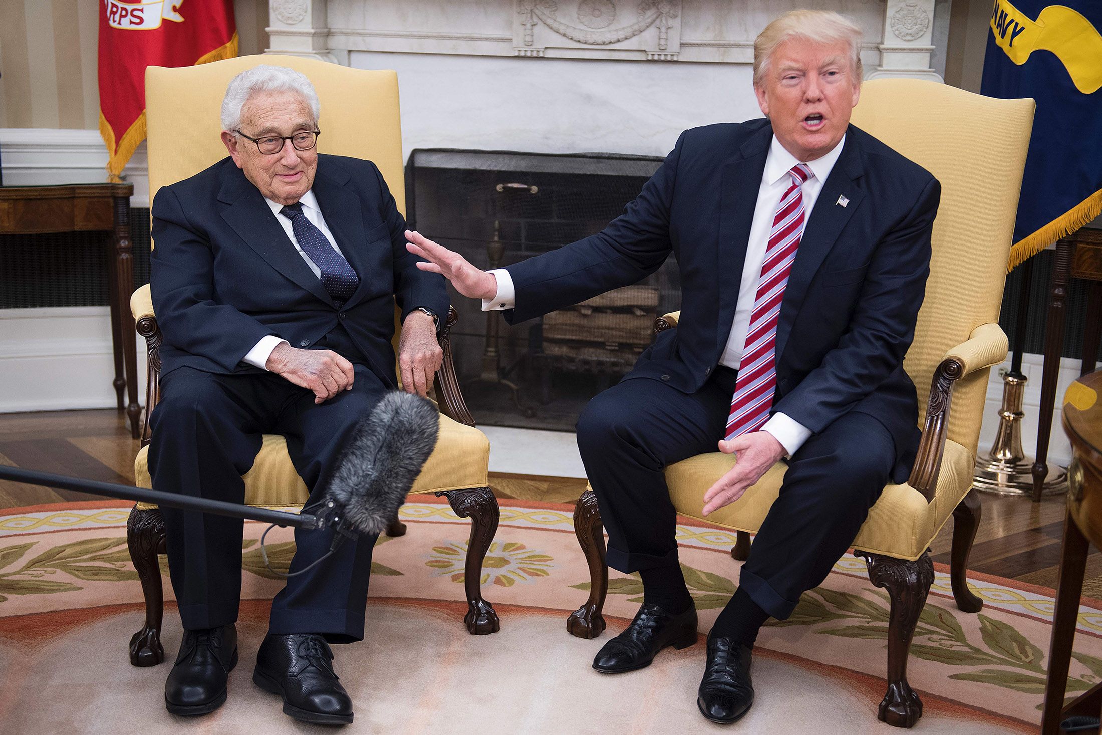 President Donald Trump speaks with Kissinger during a meeting in the White House Oval Office in 2017.