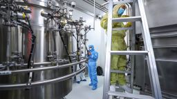 In this April 11, 2020, photo released by Xinhua News Agency, staff members check and clean equipments at a vaccine production plant of SinoPharm in Beijing. In the global race to make a coronavirus vaccine, the state-owned Chinese company is boasting that it gave its employees, including top executives, experimental shots even before the government OK'd testing in people. (Zhang Yuwei/Xinhua via AP)