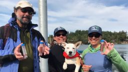  It's mission accomplished for Eba the Whale Dog, who tracks the scat of critically endangered orcas in Washington's Puget Sound with research scientists (from left) Samuel Wasser, Deborah Giles and Sadie Youngstrom.