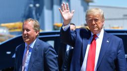 US President Donald Trump waves upon arrival, alongside  Attorney General of Texas Ken Paxton (L) in Dallas, Texas, on June 11, 2020, where he will host a roundtable with faith leaders and small business owners. (Photo by Nicholas Kamm / AFP) (Photo by NICHOLAS KAMM/AFP via Getty Images)