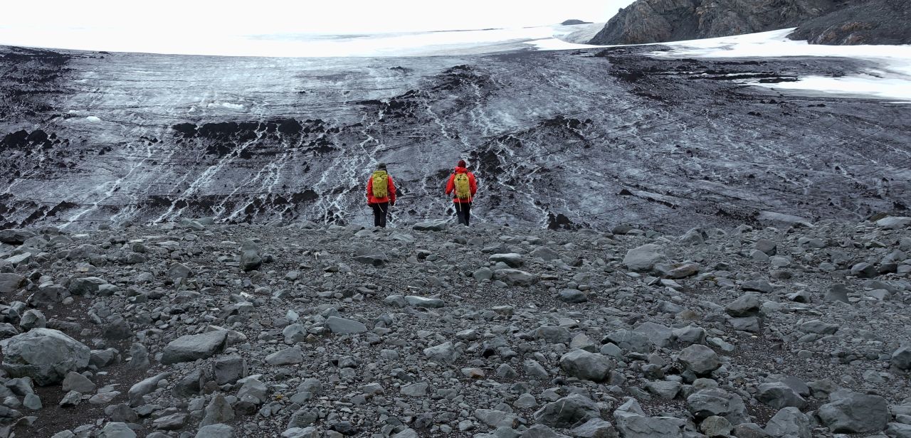 Cook's research on microscopic life forms that grow on glaciers and ice sheets has taken him from pole to pole, including an expedition to Livingston Island, Antarctica, in January 2020. He and his team were investigating microbial activity in the ice and in meltwater from several glaciers around the island as part of the UK National Environmental Research Council project "MicroMelt."