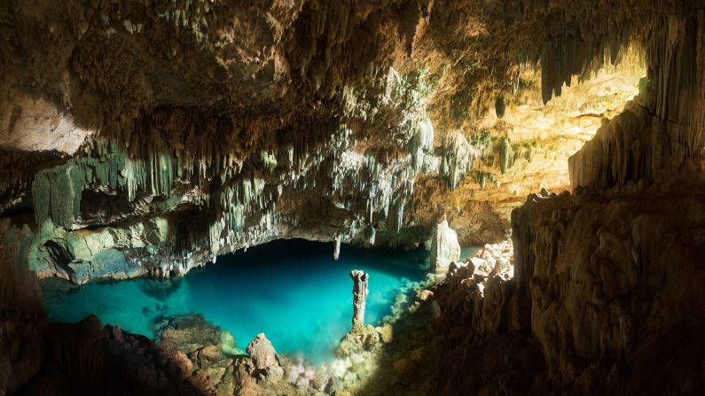 <strong>Rangko Cave:</strong> Accessible by boat, Flores' Rangko Cave is best visited in the middle of the day, when light floods through the hillside entrance and illuminates the turquoise waters below. 
