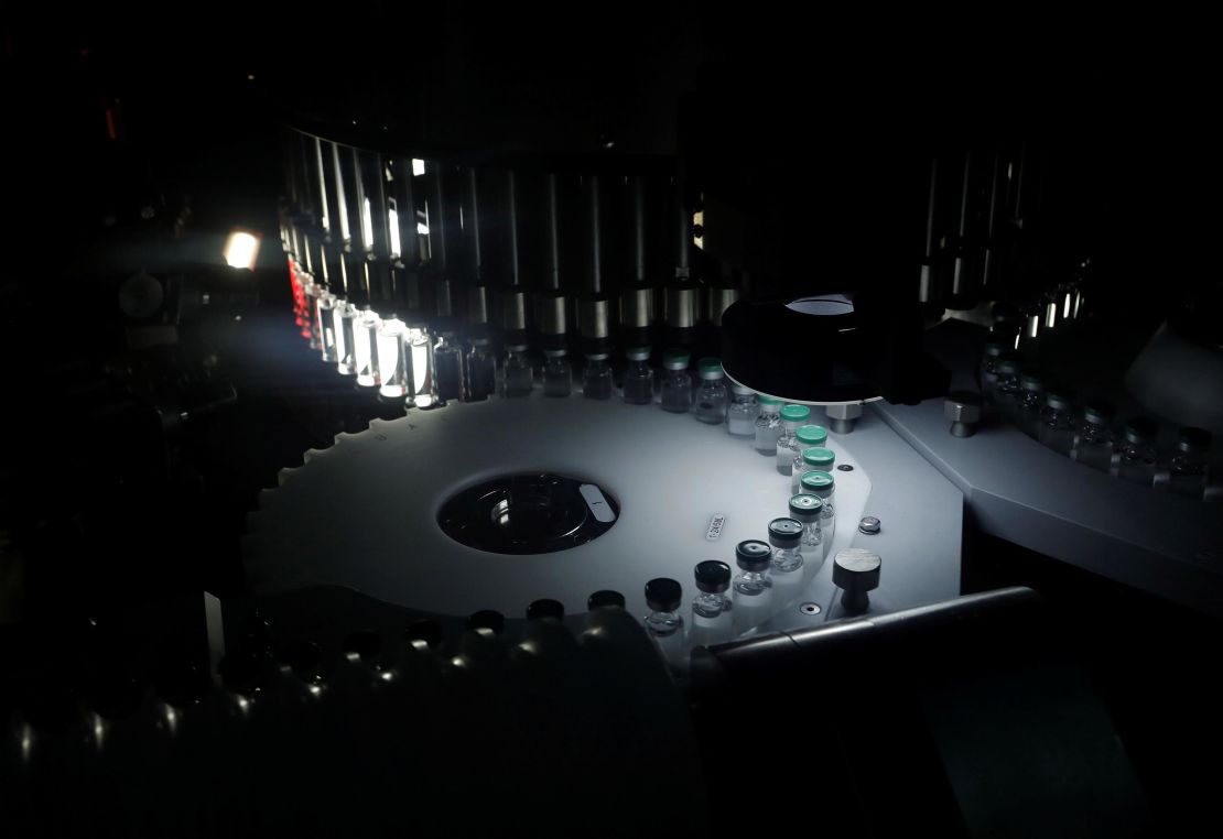 Vials of AstraZeneca's Covishield coronavirus vaccine are seen inside a visual inspection machine in a lab at the Serum Institute of India, in Pune, India.