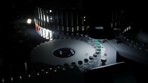 Vials of AstraZeneca's Covishield coronavirus vaccine are seen inside a visual inspection machine in a lab at the Serum Institute of India, in Pune, India.