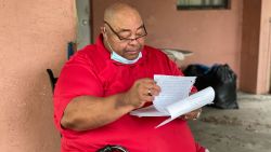 John Ayers looks through eviction documents as his eviction date looms.