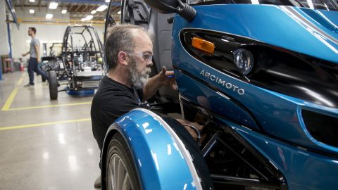 Mike Dunphy installs lower dash panels on an Arcimoto vehicle.