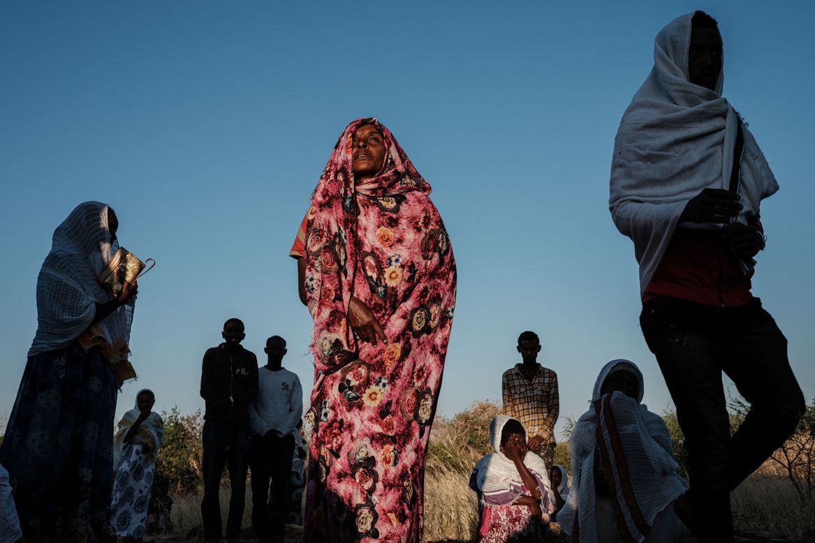 An Ethiopian refugee who fled <a href="https://www.cnn.com/2020/12/08/africa/ethiopia-tigray-refugees-sudan-border-intl/index.html" target="_blank">the Tigray conflict</a> prays during Sunday Mass at a village in Gedaref, Sudan, on December 6.